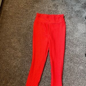 Red waffle pattern, bootylifting, spandex pants/leggings.
